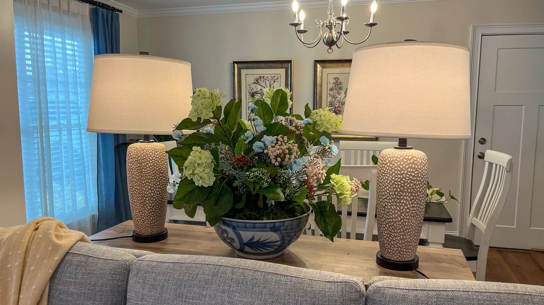 Dining console vignette with lamps and floral arrangement at Georgia Cottage