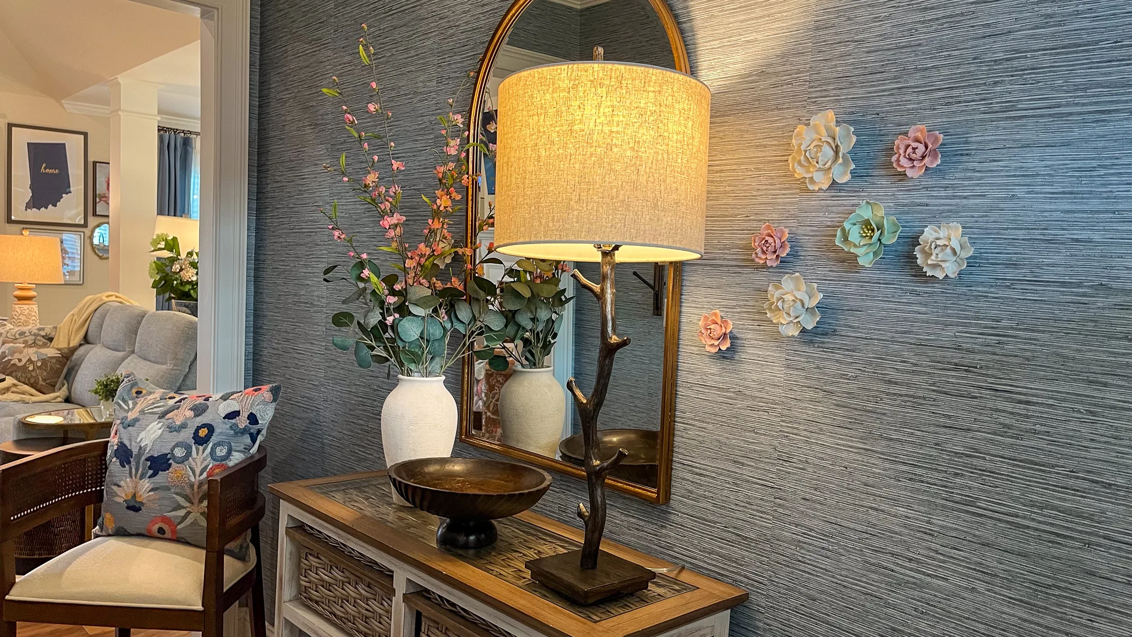 Entry hall console with arched mirror and floral styling at Georgia Cottage